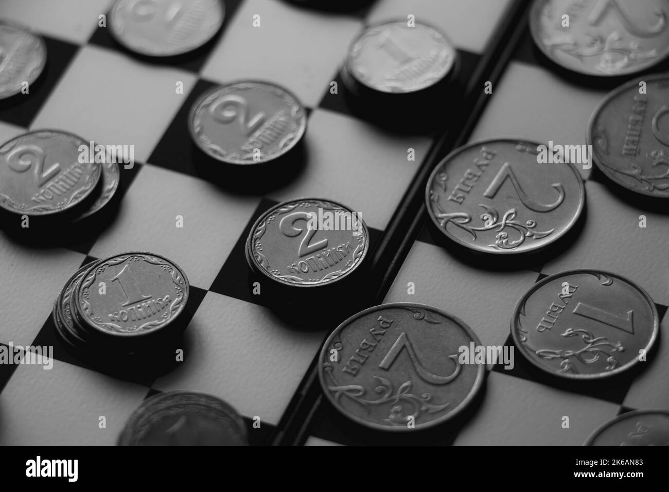 Ukrainian hryvnia and Russian rubles lie on a chessboard, sanctions in Russia, finance and economics Stock Photo