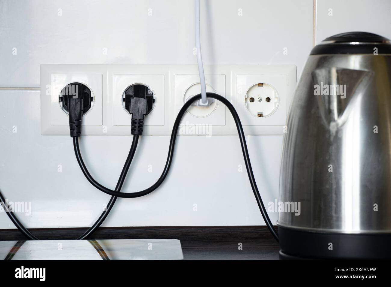 https://c8.alamy.com/comp/2K6ANEW/kitchen-and-electric-kettle-on-the-table-near-the-socket-against-the-background-of-white-tiles-kitchen-appliances-kitchen-furniture-and-appliances-2K6ANEW.jpg