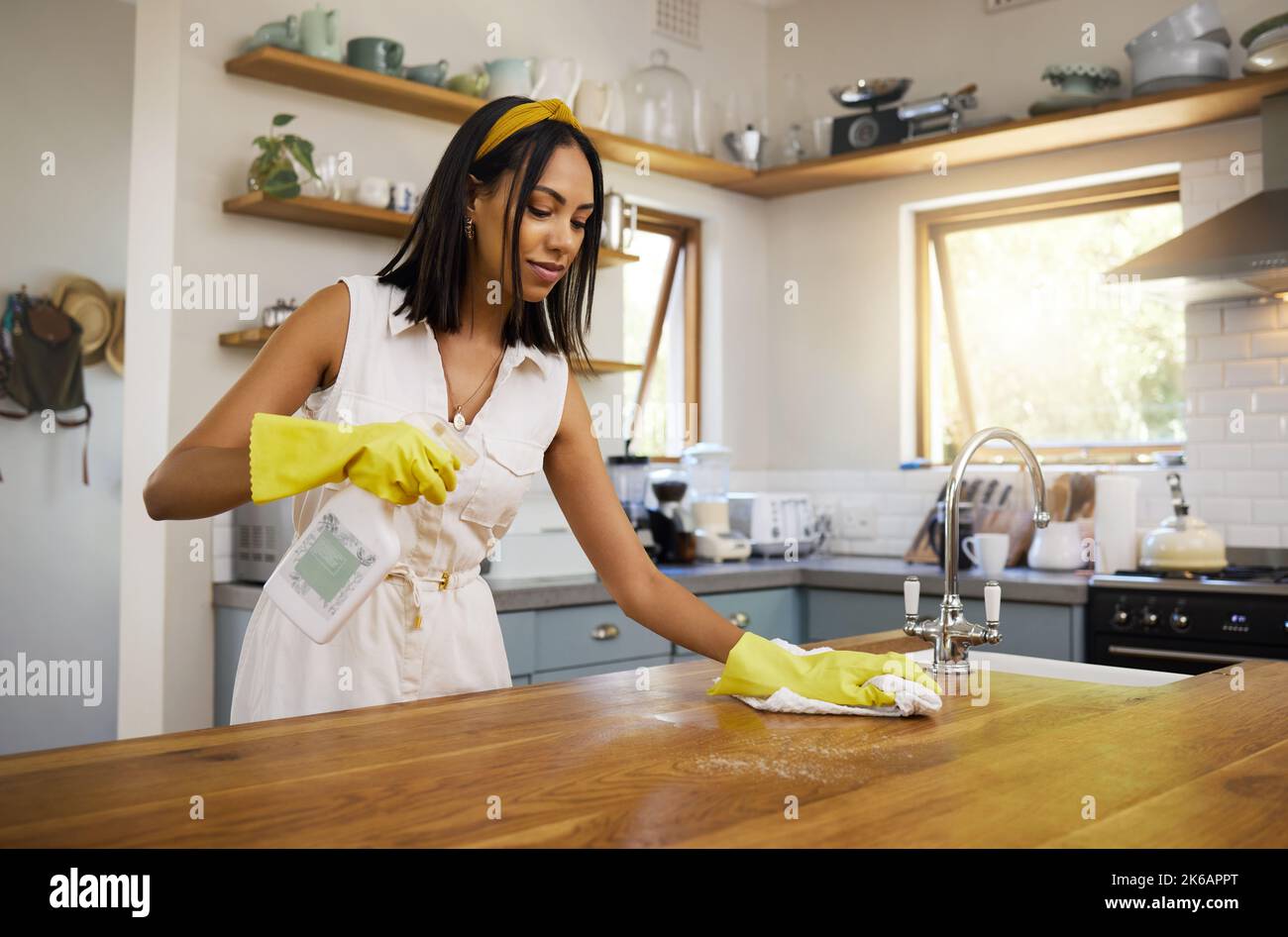 Cleaning, kitchen and housework with a woman cleaner working to keep her house hygienic and fresh. Clean, sanitize and hygiene with a female using Stock Photo