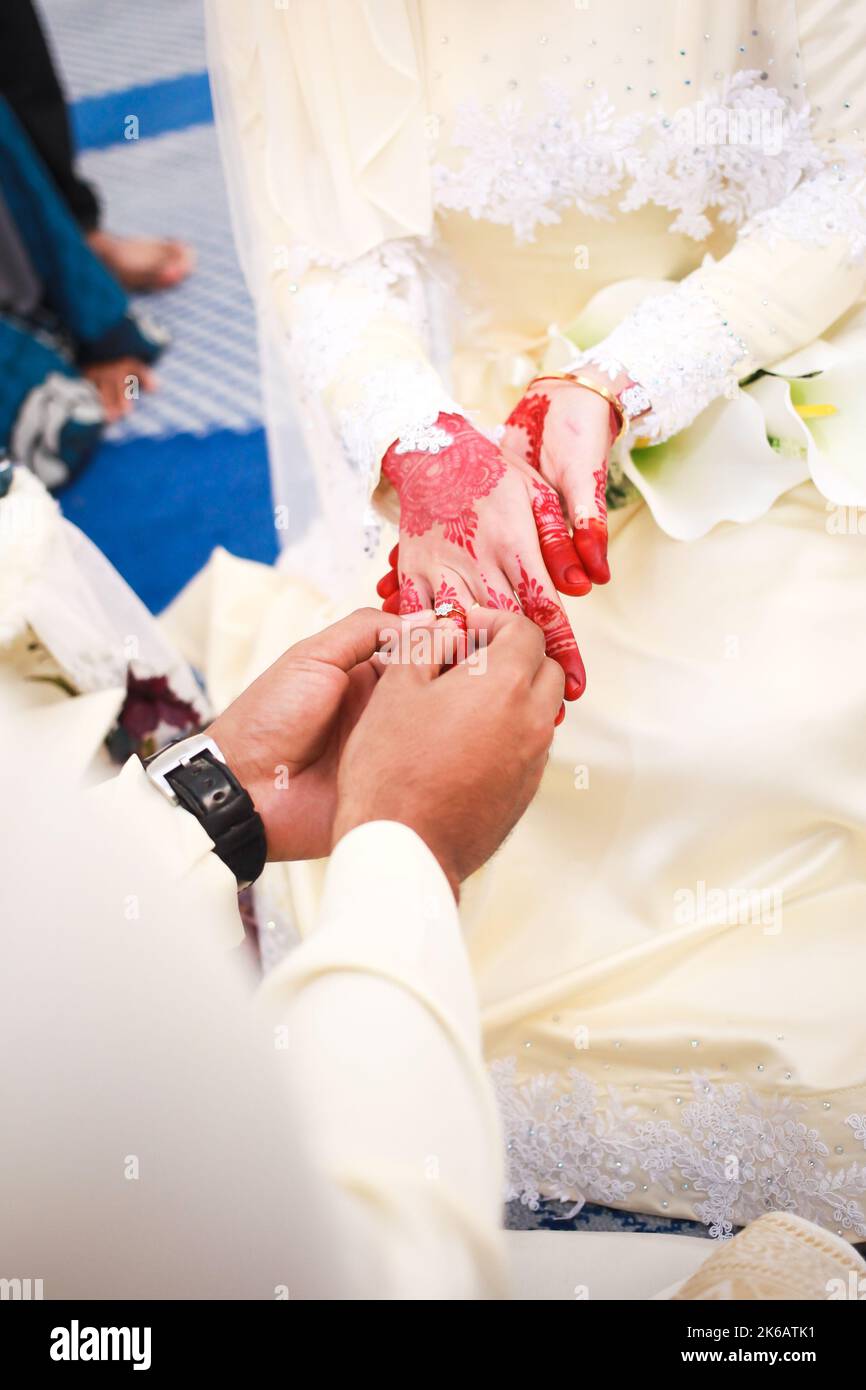 Wedding engagement rings. Married couple exchange wedding rings at a