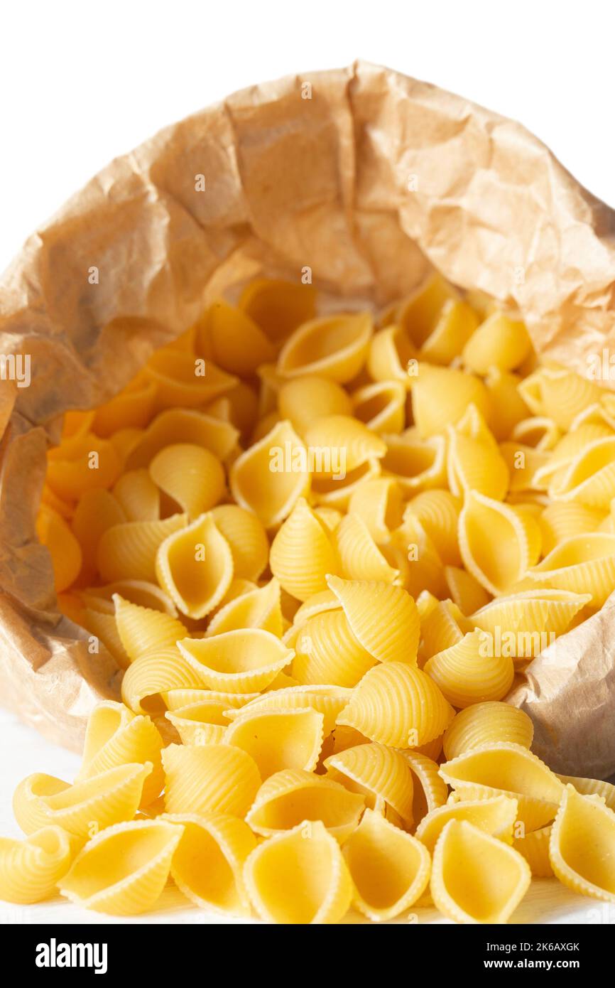Conchiglie pasta shells in a brown paper bag. Eco-friendly recycling compostable packaging Stock Photo