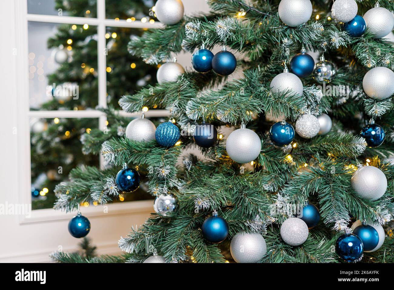 Christmas tree with blue and silver toys. Festively decorated Christmas ...