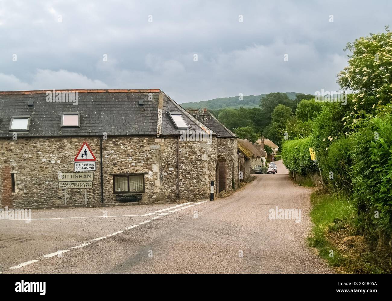 Gittisham United Kingdom - June 17 2009; Editorial- Country road into small English town with stone and. slate buildings. Stock Photo