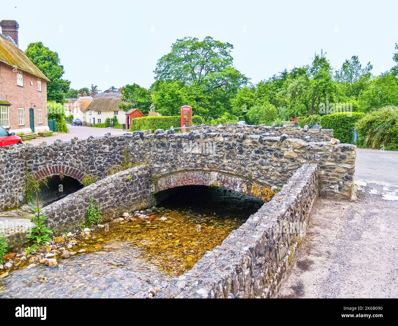 Small stone arch bridge at entry to small English village in United Kingdom. Stock Photo