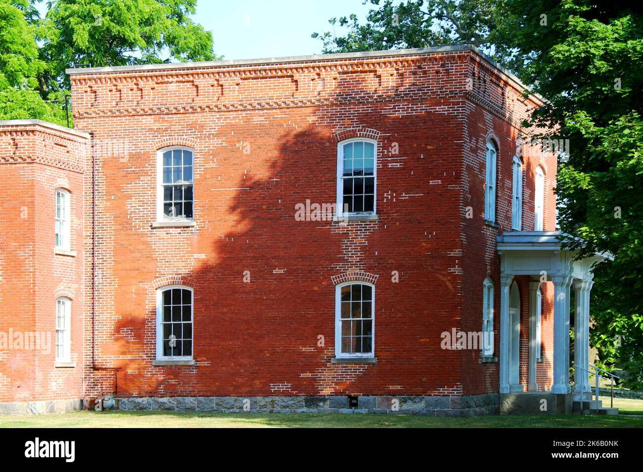 a vintage deserted abandoned manor house derelict stately home historic empty mansion red brick weathered old county building Stock Photo