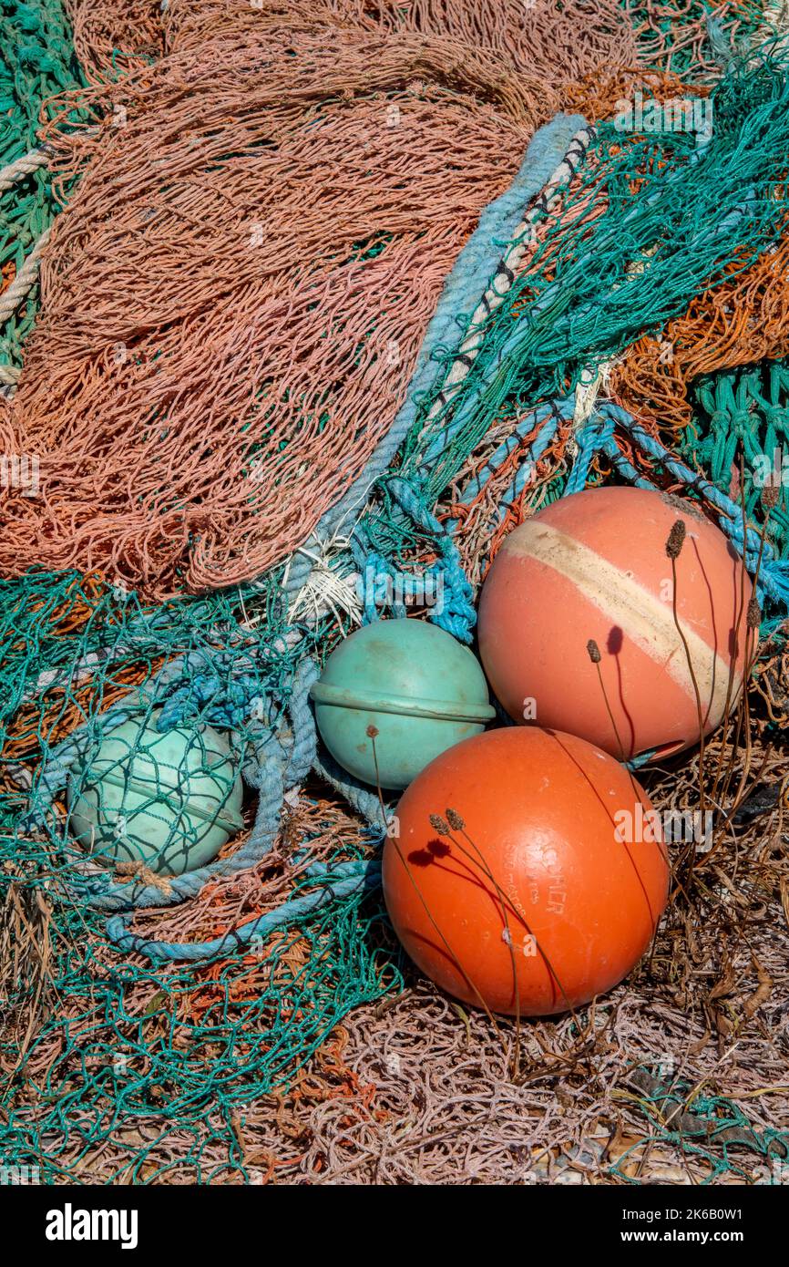 tangled fishing ropes and nets in an abstract composition, plastic nets and fishing gear, plastics used for fishing tackle, trawlers fishing gear. Stock Photo