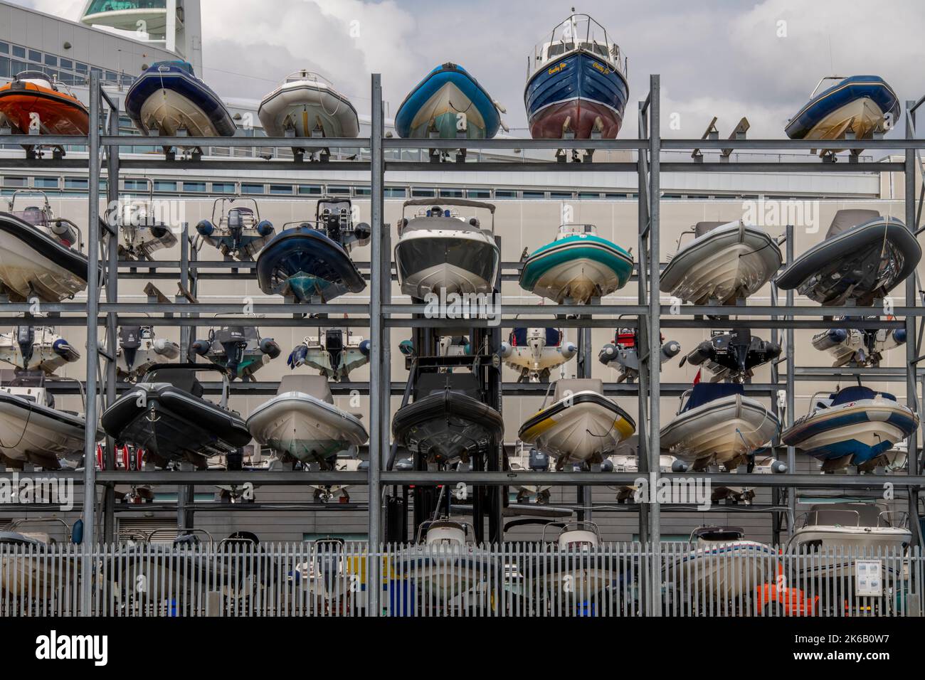 boat storage ashore in boatyard at portsmouth harbour uk, winter storage for small boats and ribs, boats stacked on a frame for storage during winter. Stock Photo