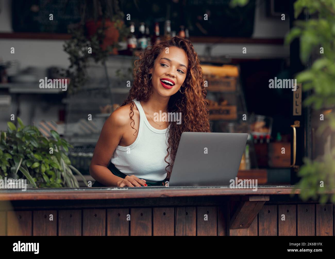 Woman, laptop and ideas in coffee shop, restaurant or Brazilian cafe for remote work, blog writing or ebook planning. Smile, happy and curious student Stock Photo