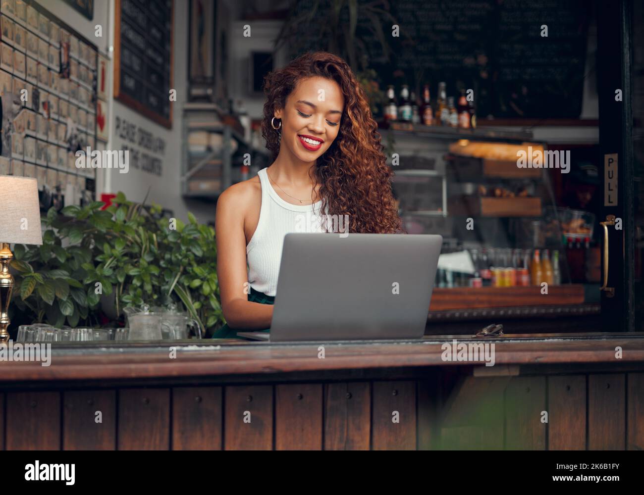 Remote work, laptop and woman at restaurant typing blog article with ...
