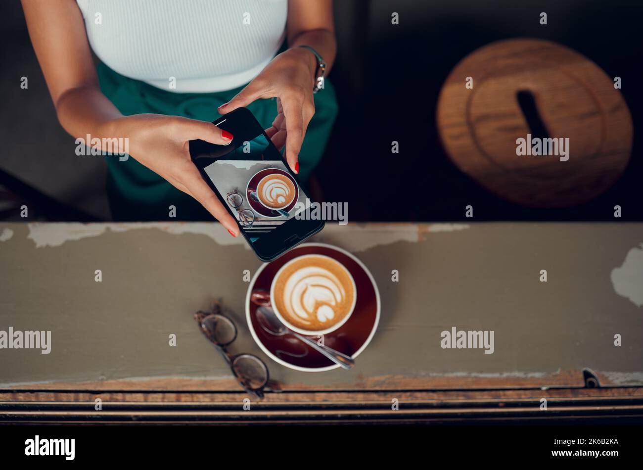 Phone, cappuccino and social media influencer at breakfast blogging or vlogging her food at a restaurant business. Content creator and social media Stock Photo