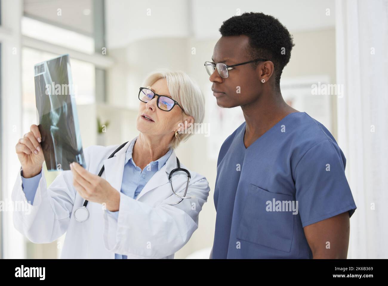 Medical team analysing an xray together on white background Stock Photo ...