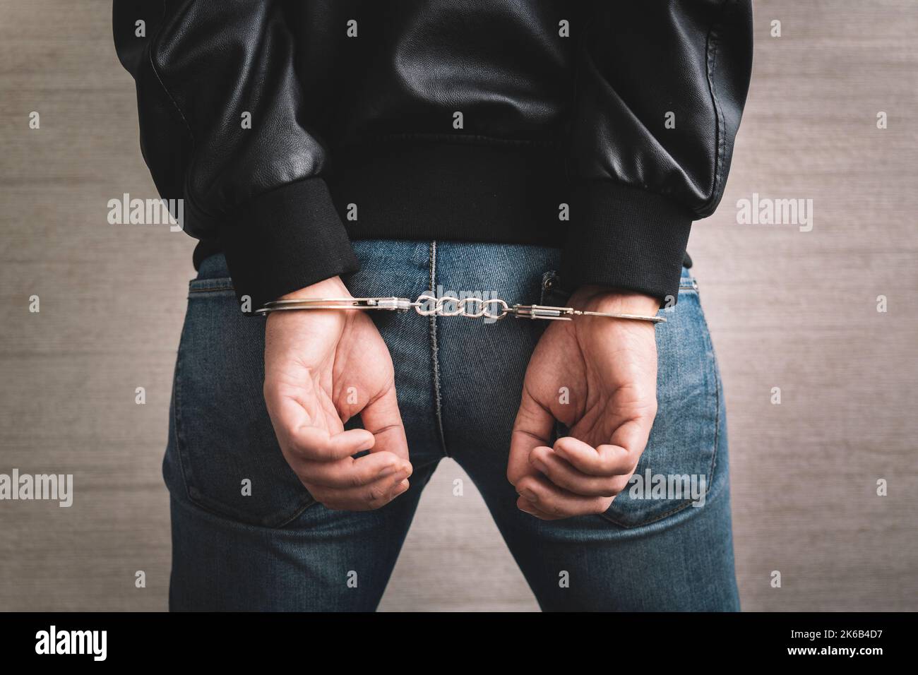 Arrested man handcuffed hands at the back. prisoner concept, Handcuffed