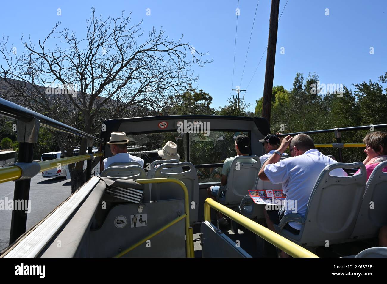 Hop on Hop off bus with tourists on the upper deck. Stock Photo