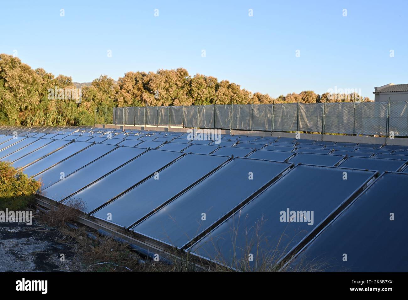 Close up view on solar or photovoltaic panels placed on a meadow in dense rows in Crete, Greece. Stock Photo