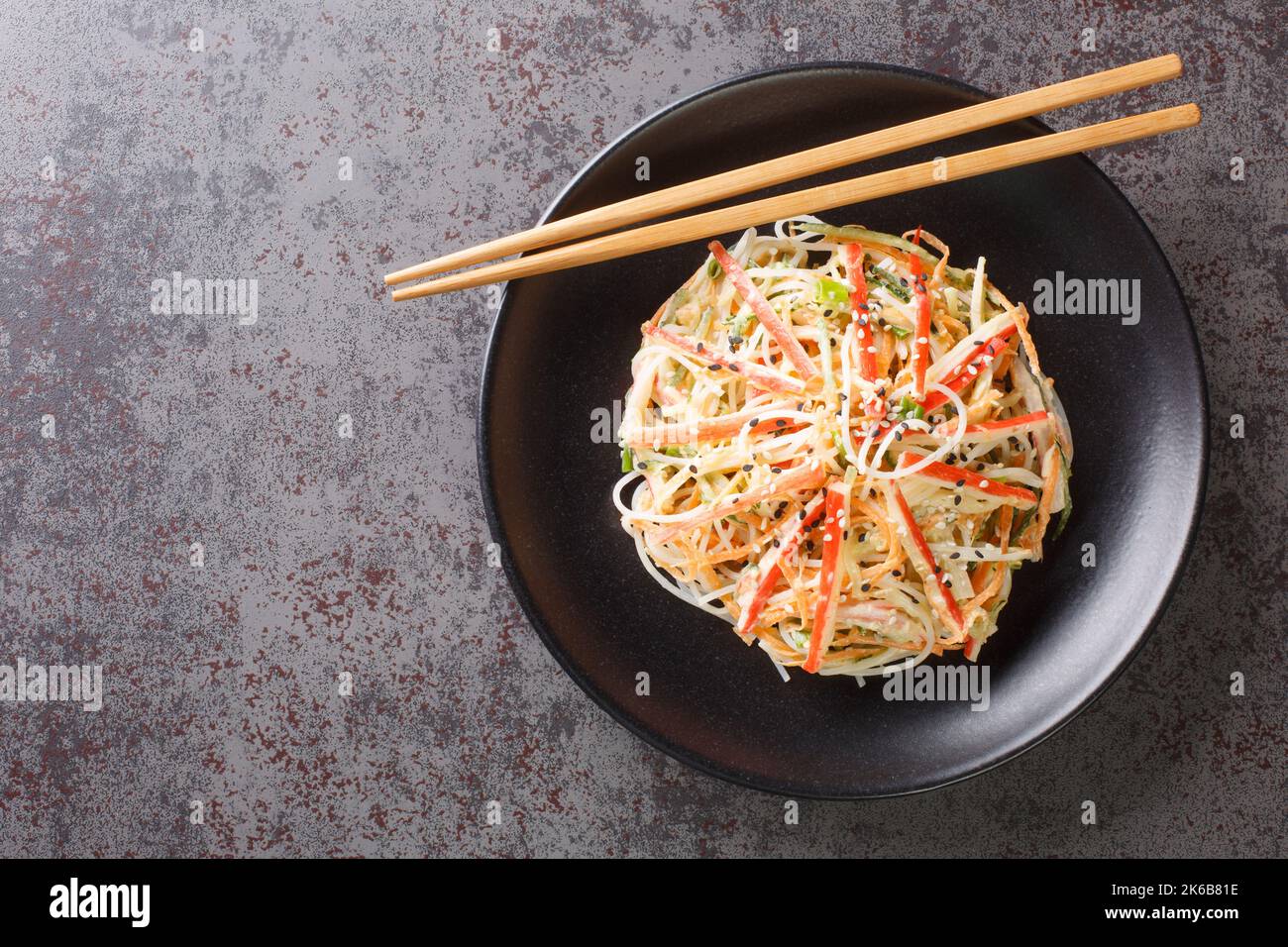 Kani or kanikama salad is a Japanese crab salad that is a delicious mix of crab meat crunchy cucumber and carrots and spicy mayonnaise dressing closeu Stock Photo