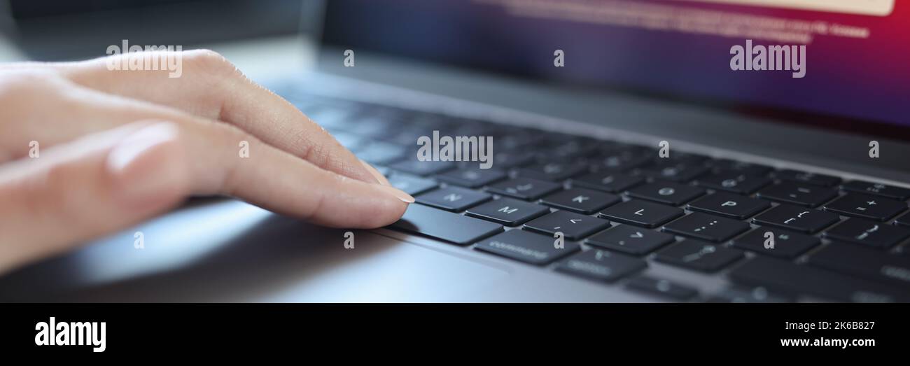 Closeup of writer hand writing on laptop on desk at home or office Stock Photo