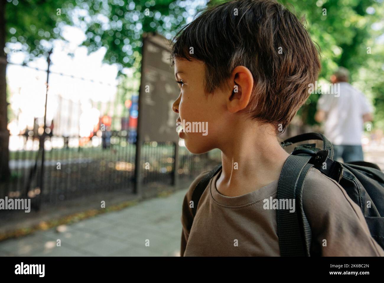 Thoughtful boy looking away wearing backpack Stock Photo
