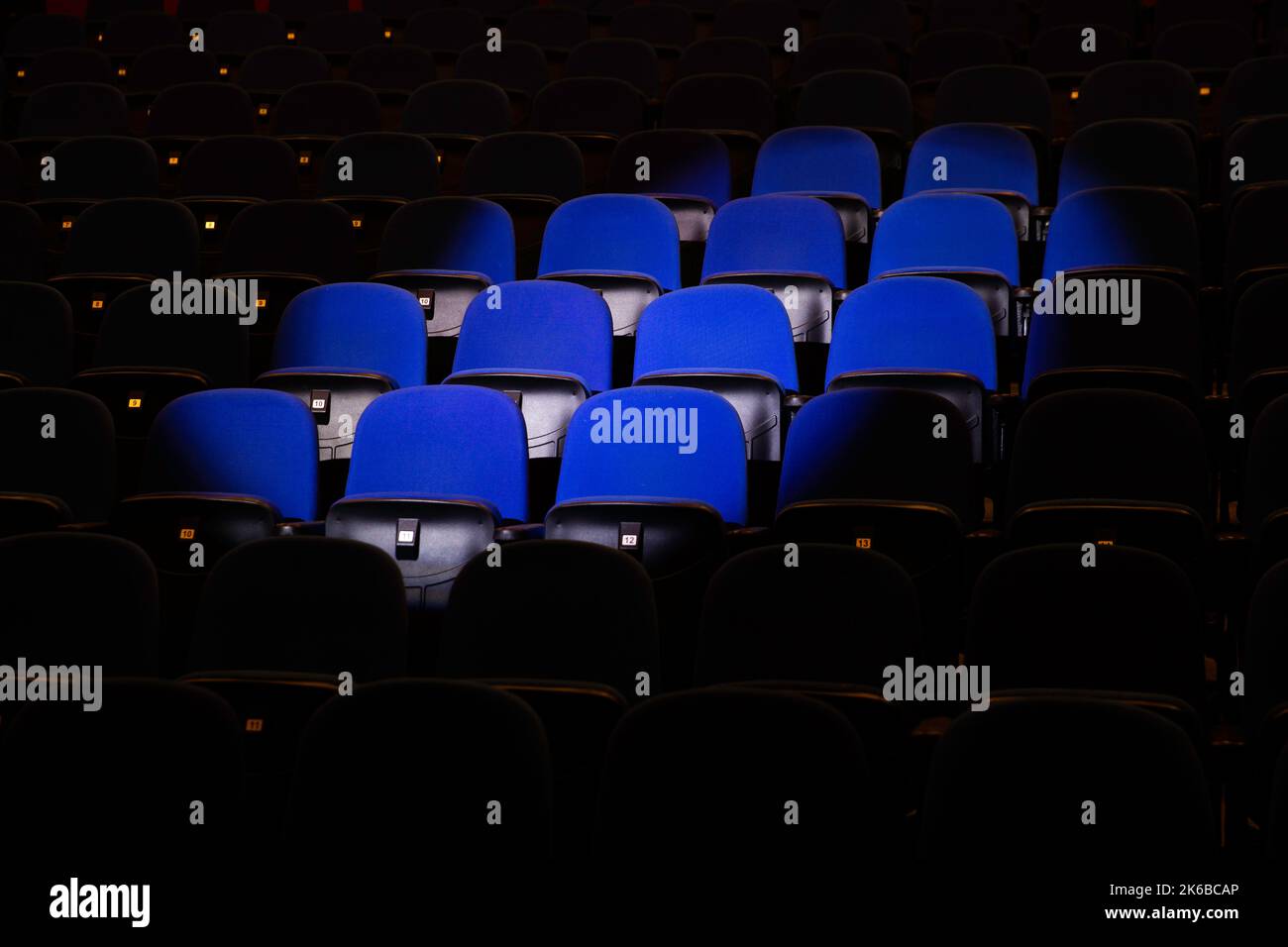 Close up shot of interior of cinema auditorium with lines of blue