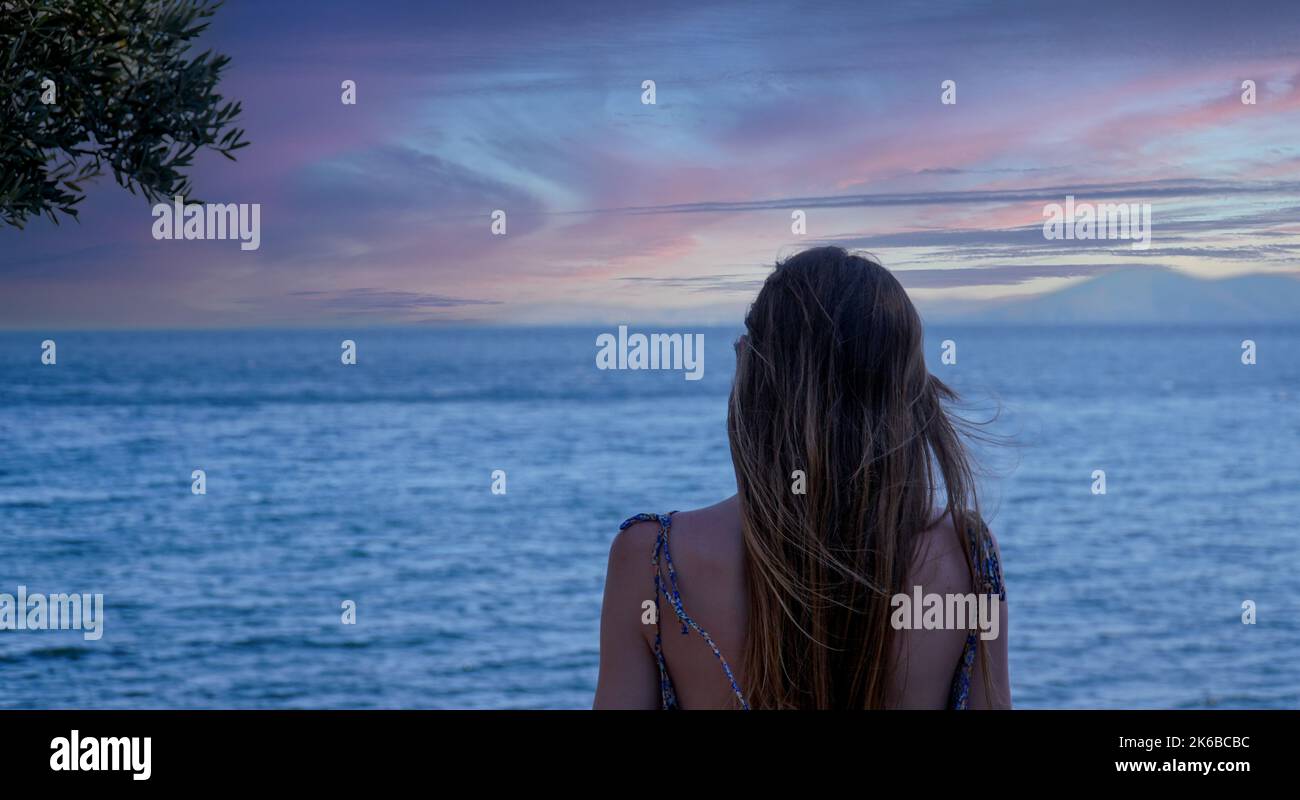 Blonde woman sitting alone hi-res stock photography and images - Alamy