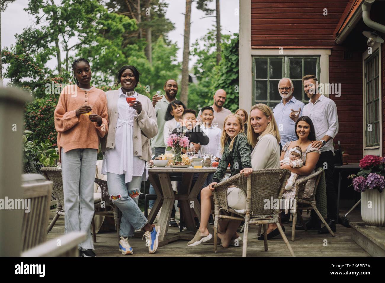 Portrait of multi-generation family during birthday celebration on porch Stock Photo