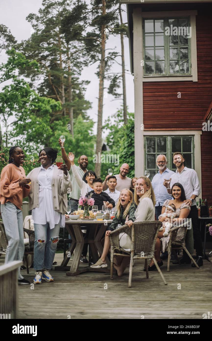 Happy multi-generation family enjoying birthday party on porch Stock Photo
