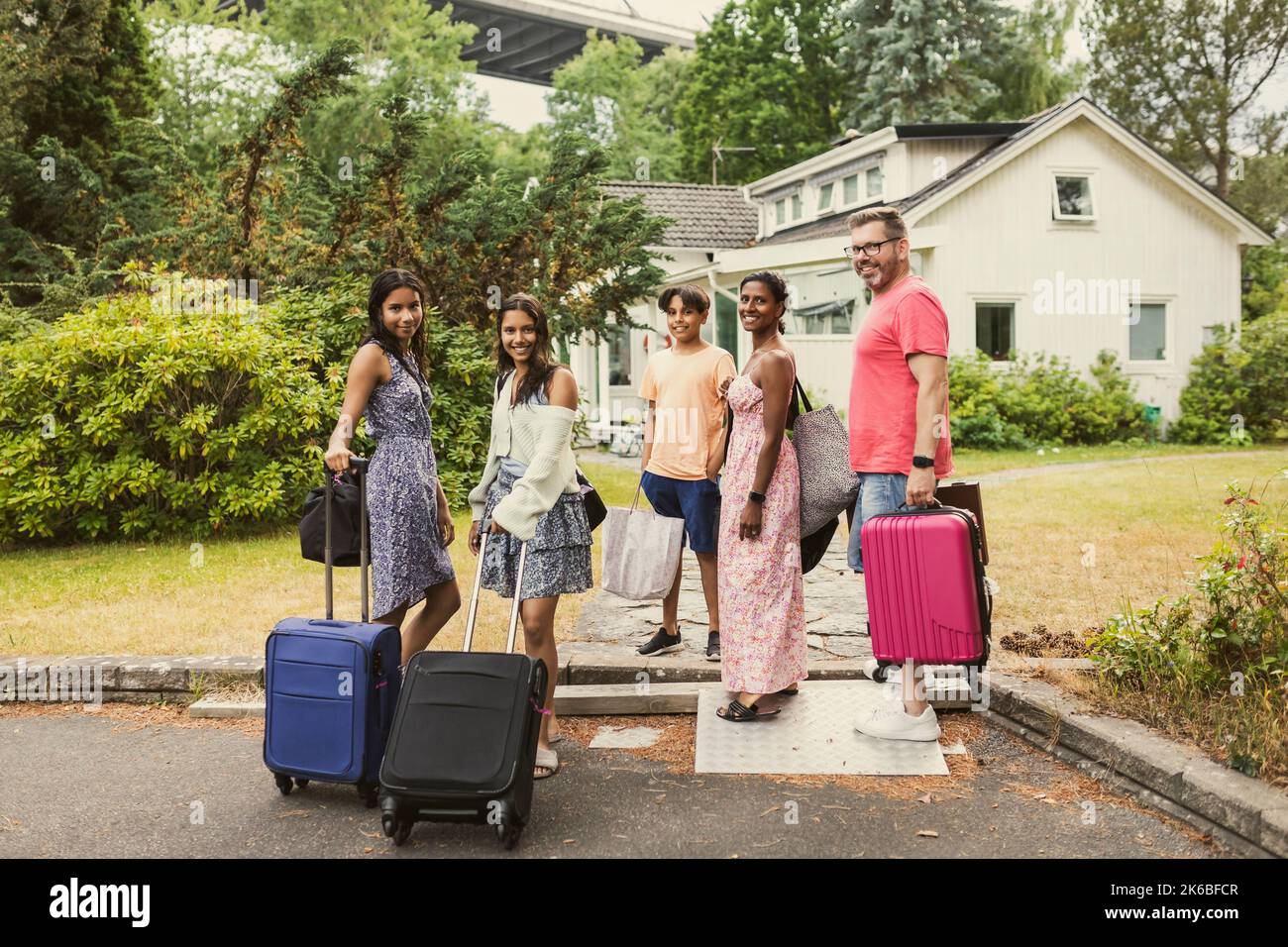 Family standing in front of house hi-res stock photography and images ...