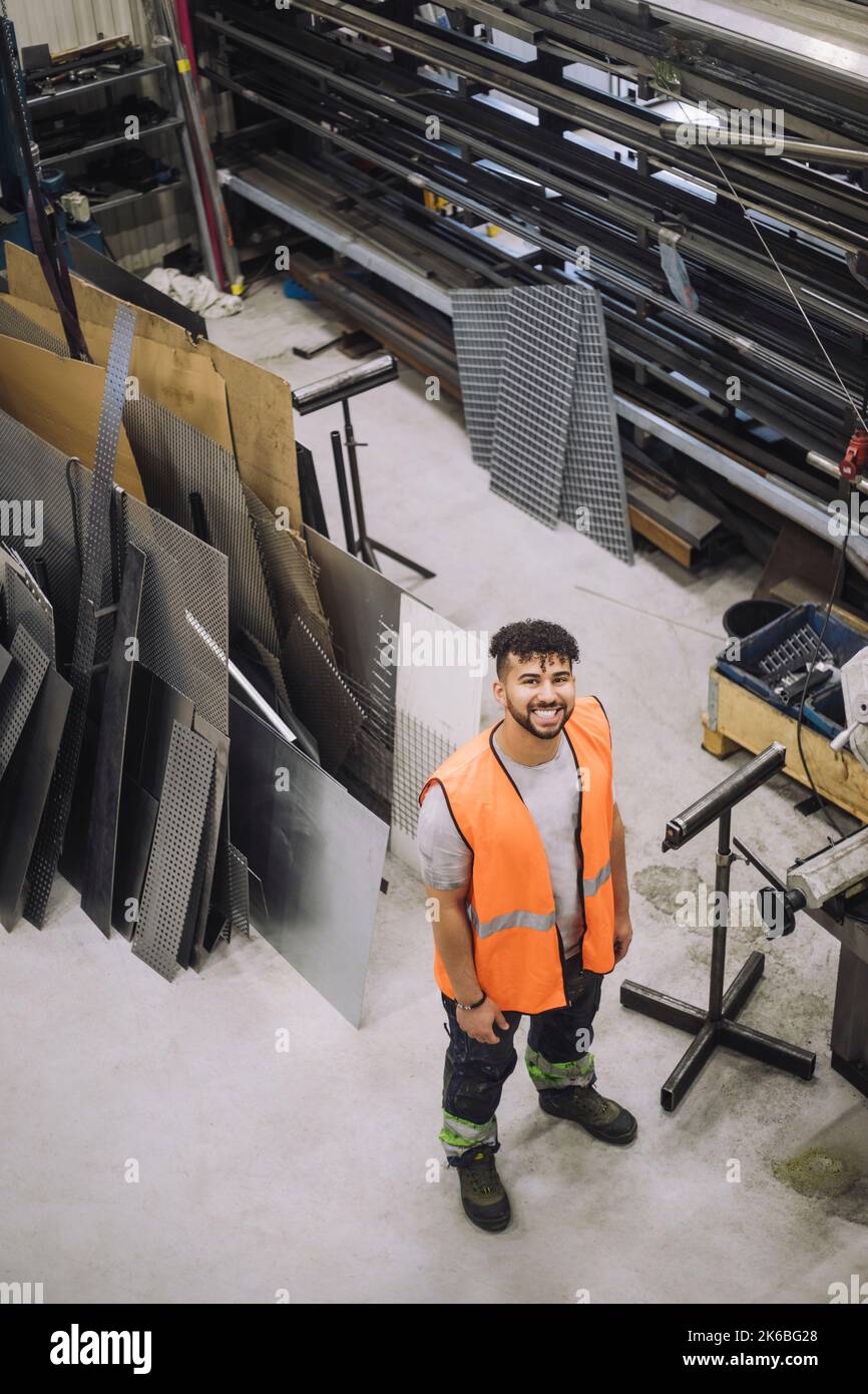 High angle view of happy young male carpenter working in workshop Stock Photo