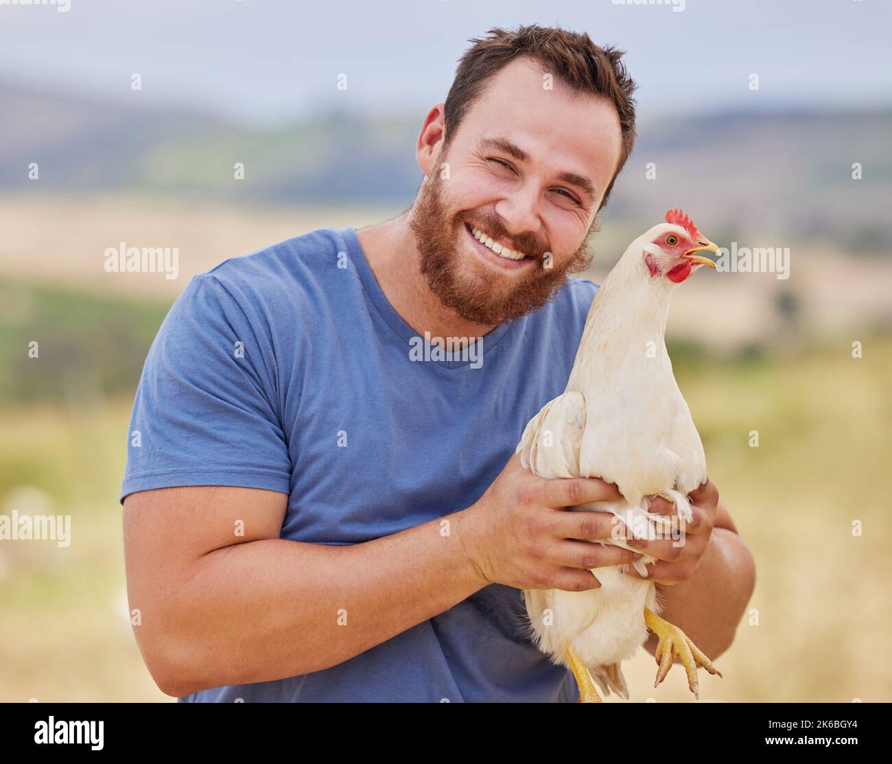 This ones a spring chicken. Portrait of a young man working on a poultry farm. Stock Photo