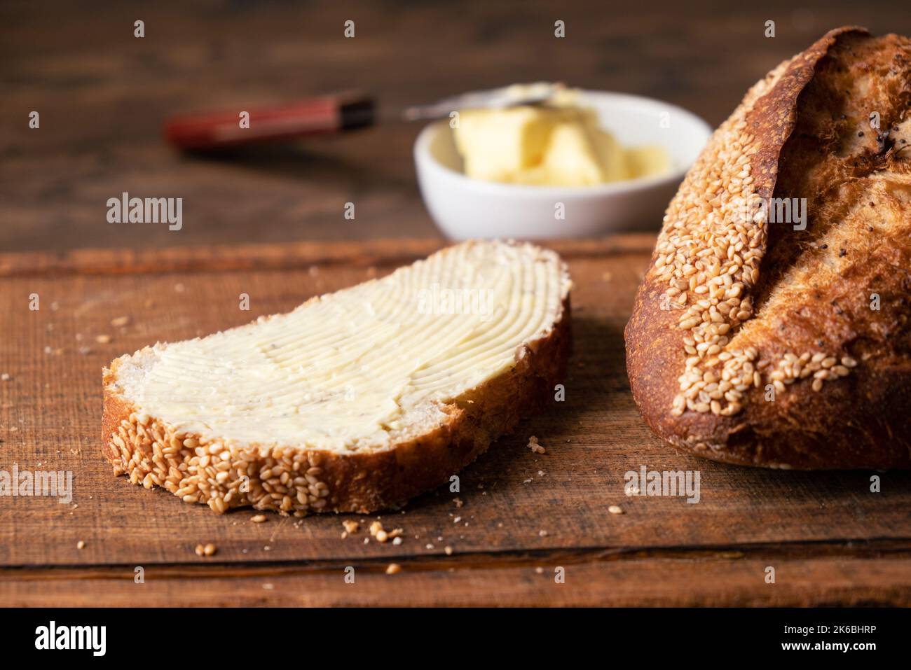 Bread with butter on wooden board. Closeup view Stock Photo