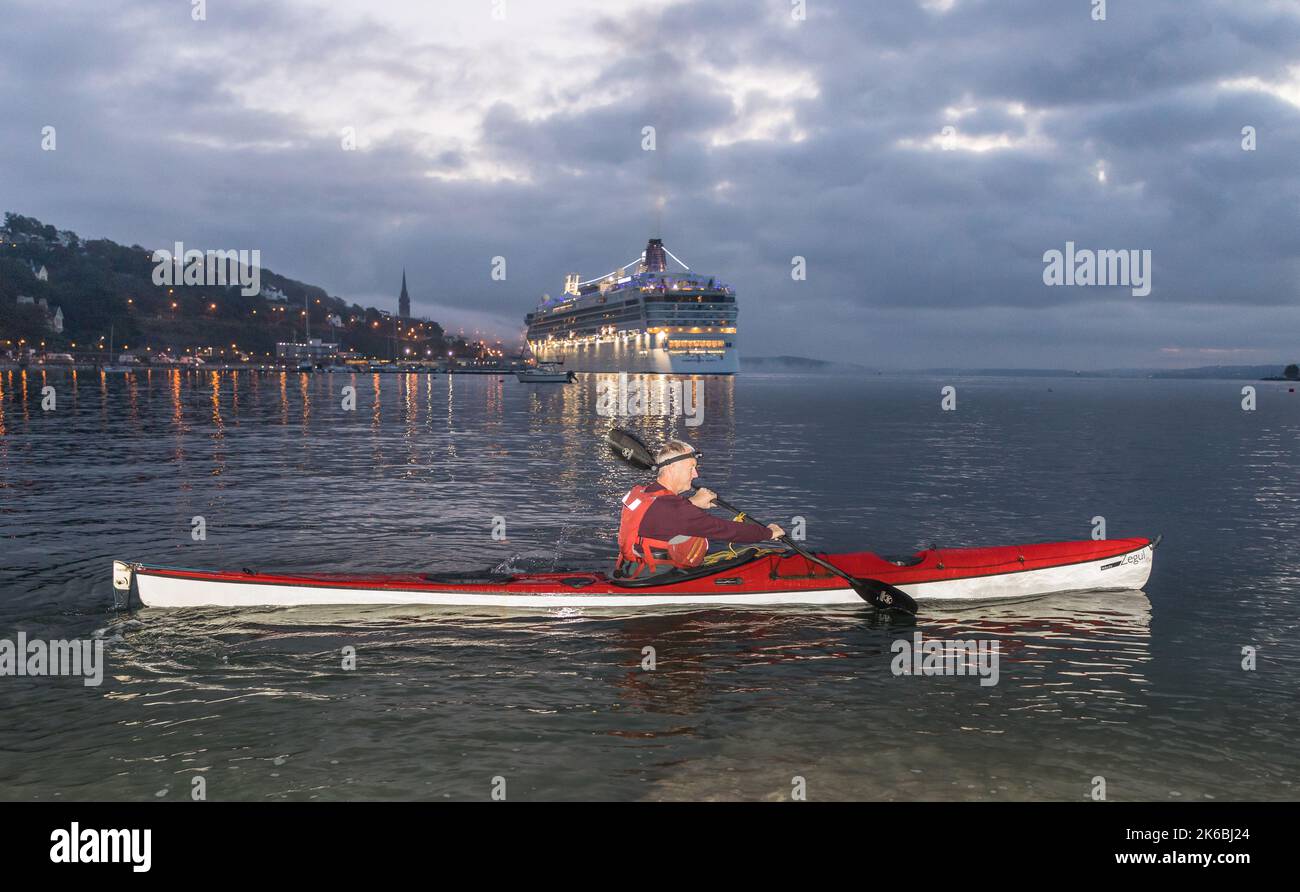 Cobh, Cork, Ireland. 13th October, 2022. Kayaker Paddy O' Donovan heads out for his daily morning paddle around Spike Island as the cruise ship Norwegian Dawn arrives before dawn in Cobh, Co. Cork, Ireland. - Credit; David Creedon / Alamy Live News Stock Photo