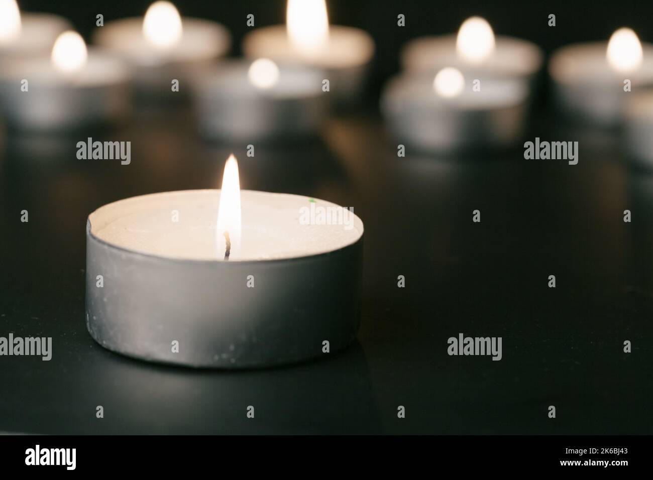 Candles Burning at Night. White Candles Burning in the Dark Stock Photo