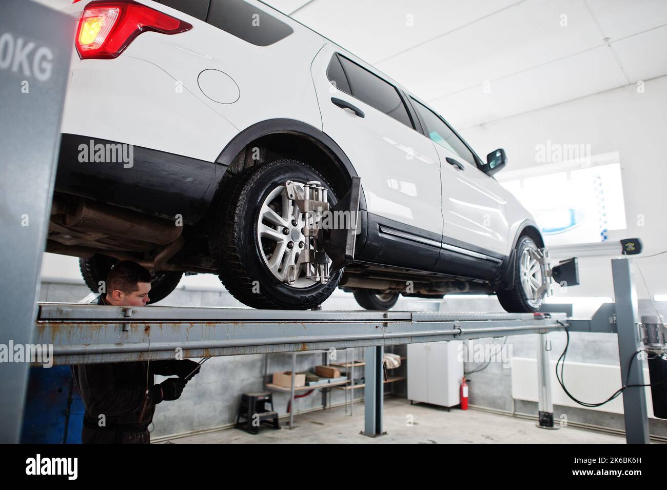 Auto mechanic sets american SUV car for diagnostics and configuration ...