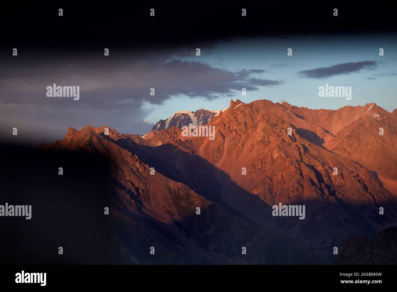 Beautiful sunrise scenery of the mountains summit with glacier and snow in Almaty, Kazakhstan. Outdoor and hiking concept Stock Photo