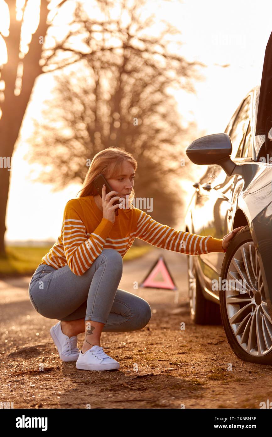 Woman Calling For Help On Phone After Car Breakdown On Country Road ...