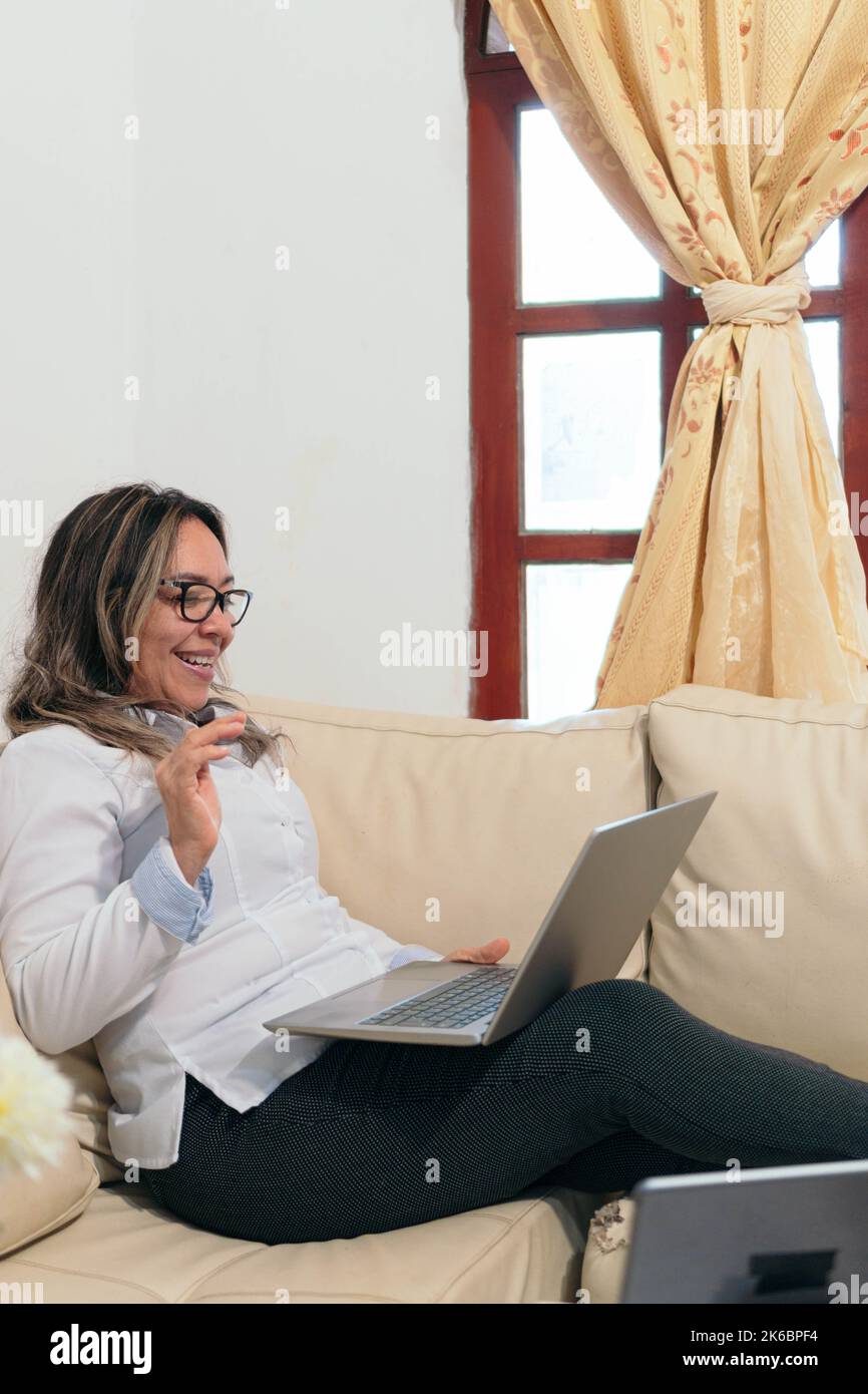 Mature woman sitting on her sofa hi-res stock photography and images ...