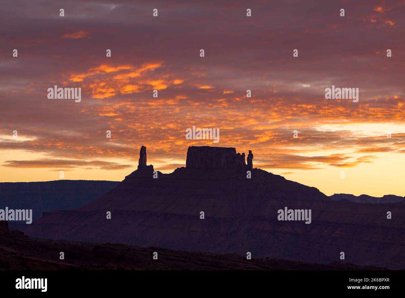 Colorful sunset clouds over the Castleton Tower / Castle Rock, the Rectory and Priest and Nuns near Moab, Utah. Stock Photo