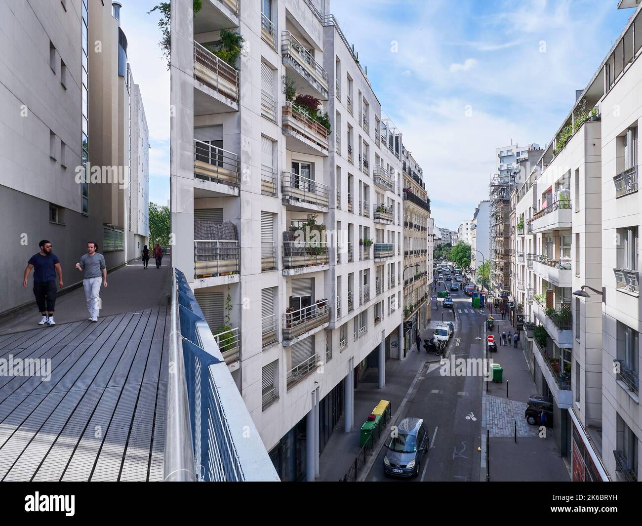 Green belt, pedestrian zone in Paris path between buildings in “rue Charenton” street, in the
