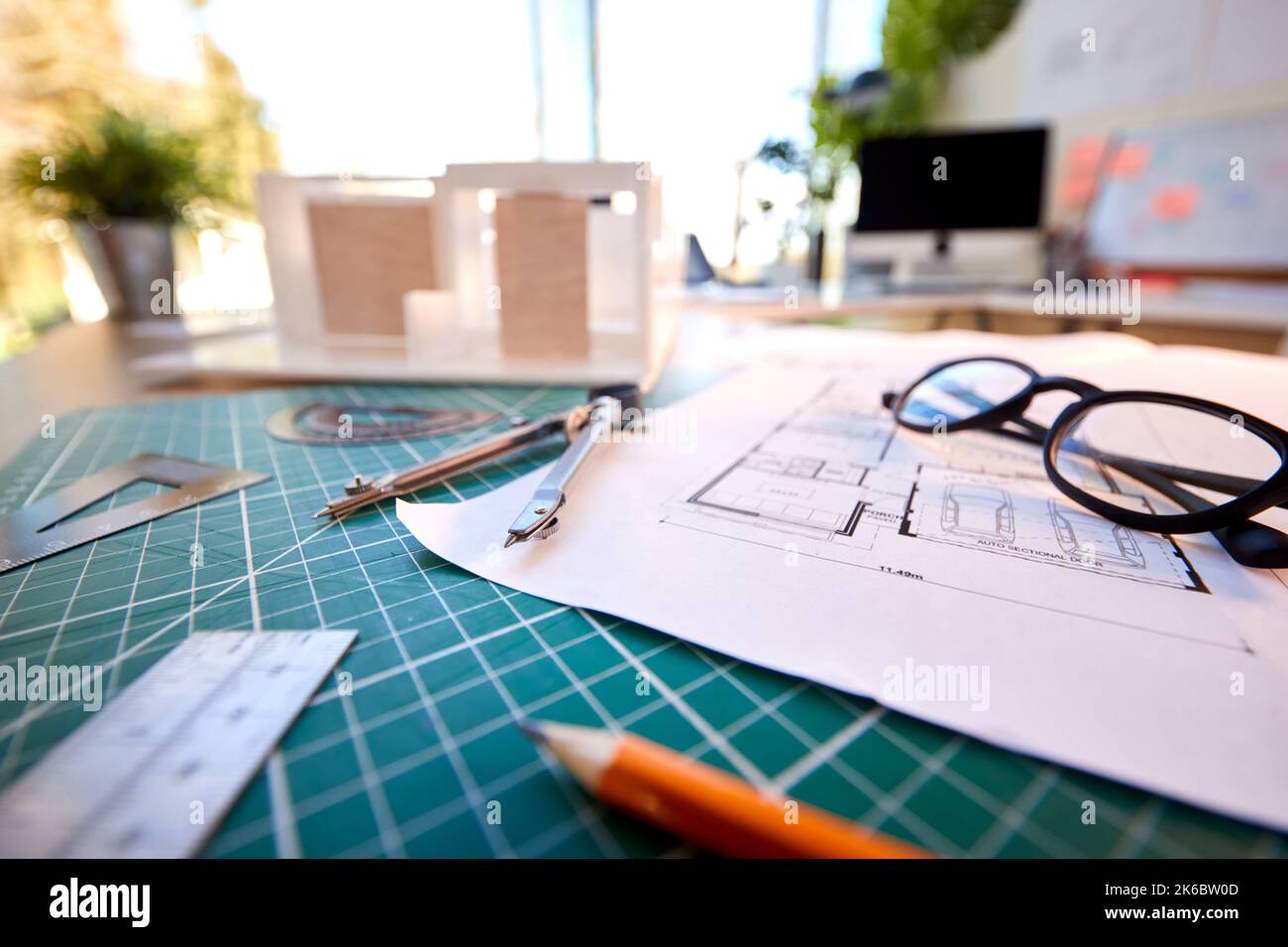 Desk In Architects Office With Plans Drawing Instruments And Model Stock Photo