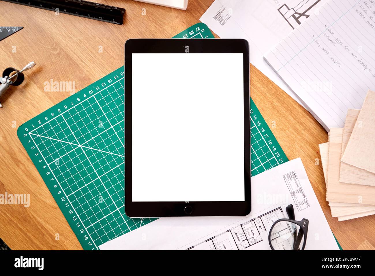 Overhead Shot Of Desk In Architects Office With Plans Drawing
