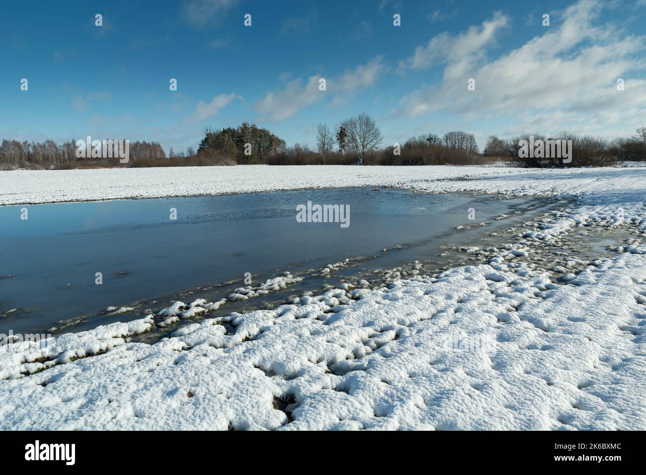 Frozen water and snow on the farmland Stock Photo