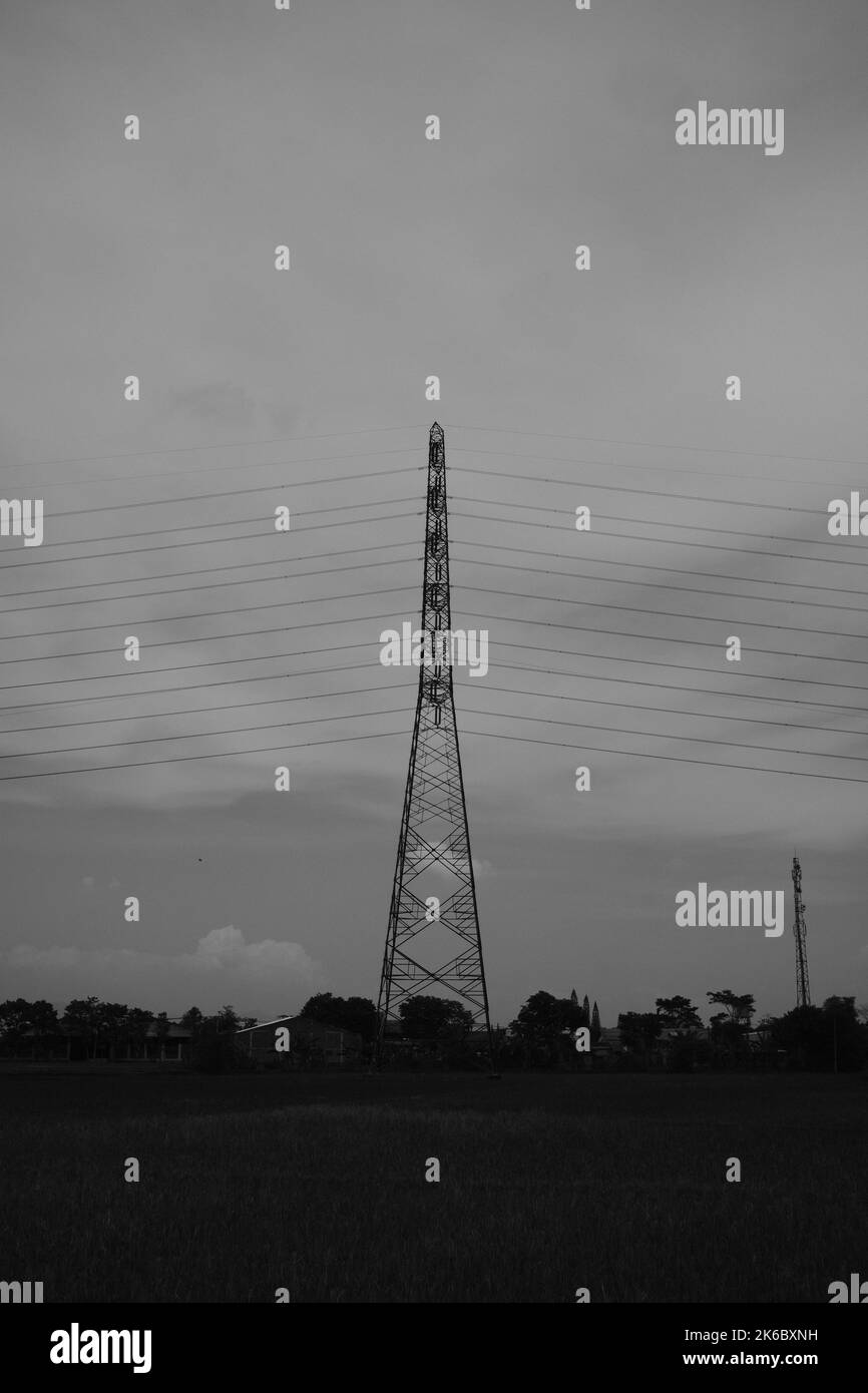 Monochrome photo, view of signal tower and electricity distribution