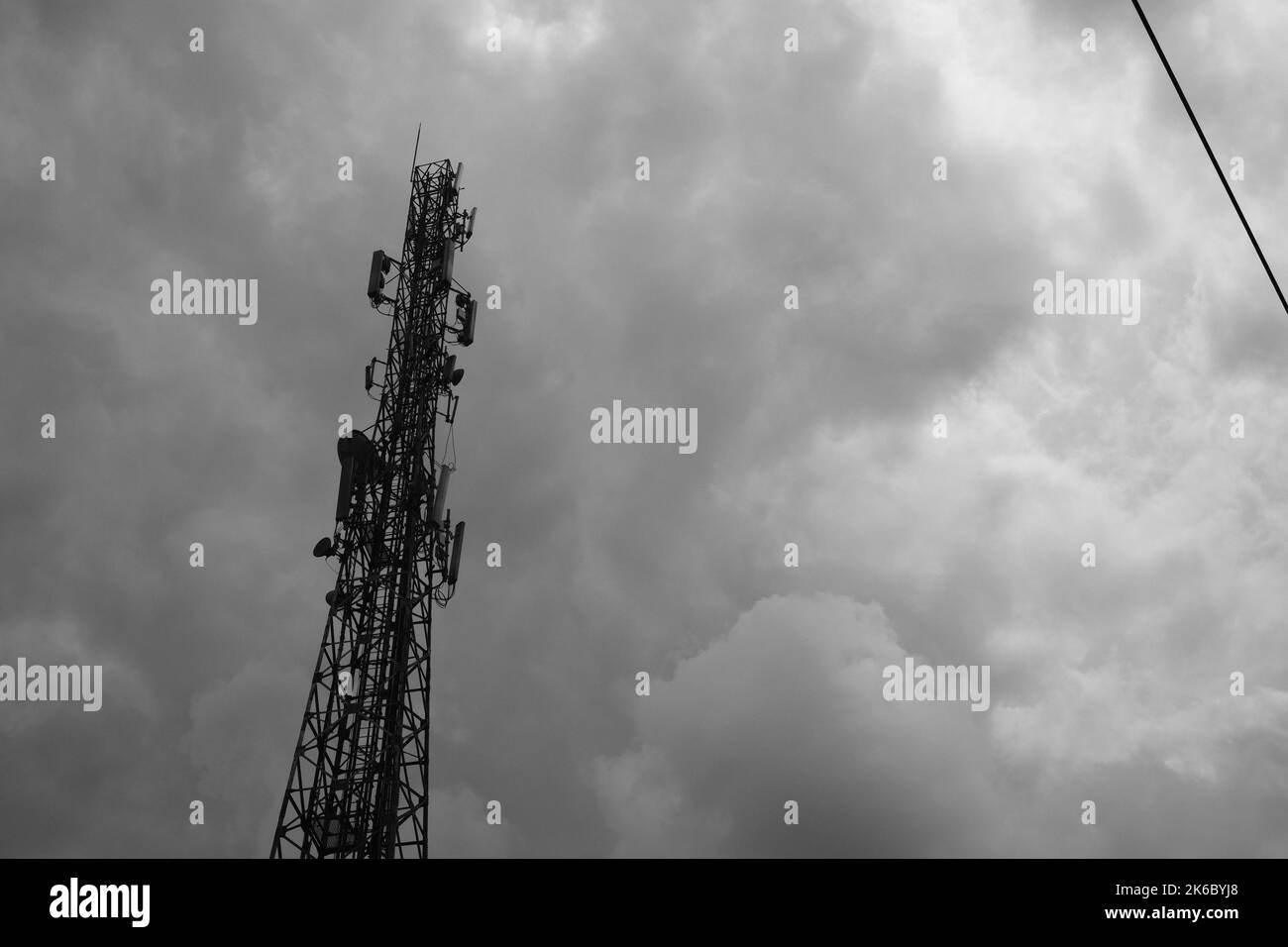 Monochrome photo, view of signal tower and electricity distribution