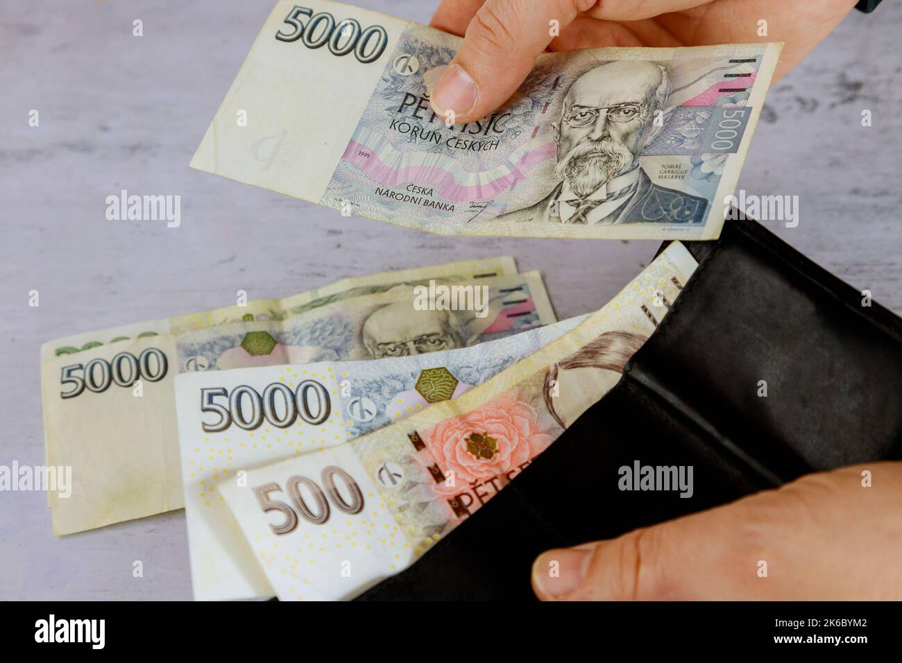 counting-czech-korunas-czk-in-his-wallet-with-czech-banknotes-from