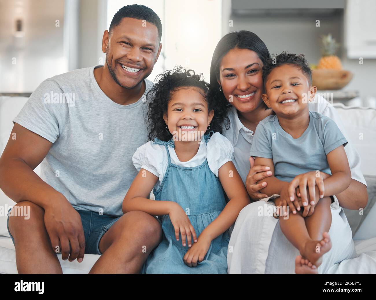 Weve arrived. a young family happily bonding together on the sofa at home. Stock Photo