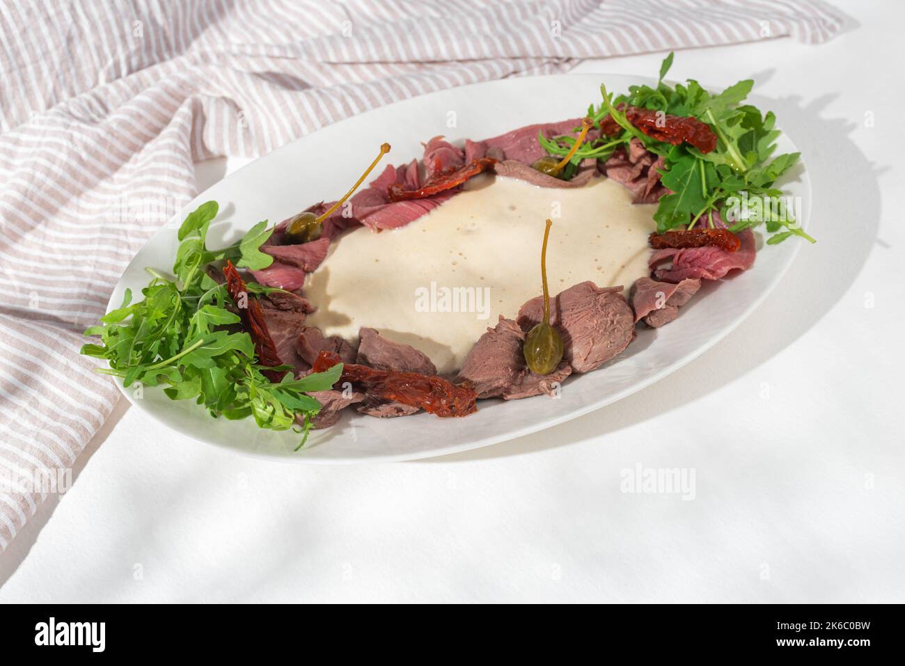 Vitello tonnato italian dish. Thin sliced veal with tuna sauce, capers