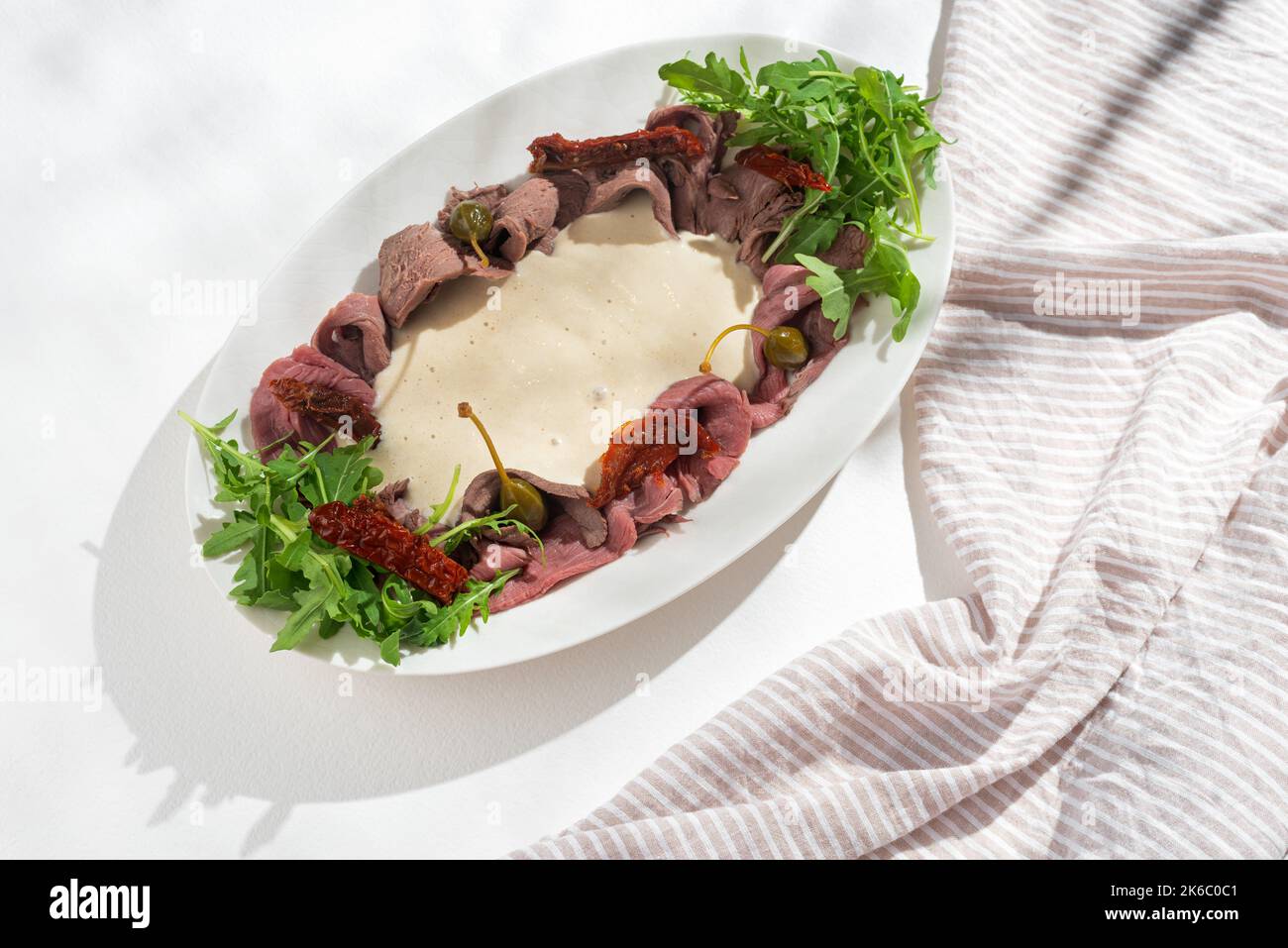 Vitello tonnato italian dish. Thin sliced veal with tuna sauce, capers