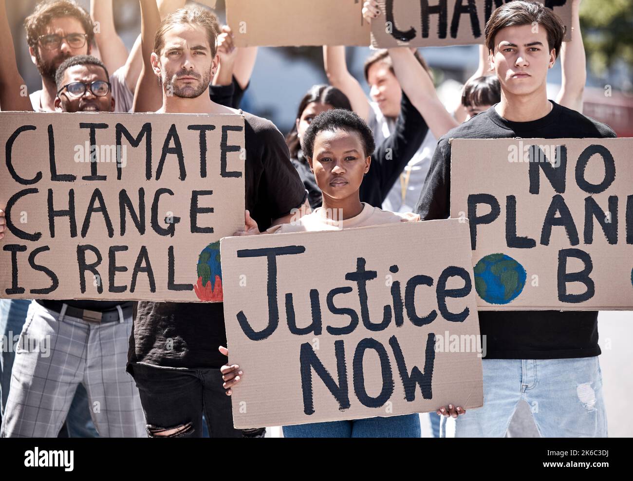 Creating the world we want to live in. a group of young people protesting climate change. Stock Photo