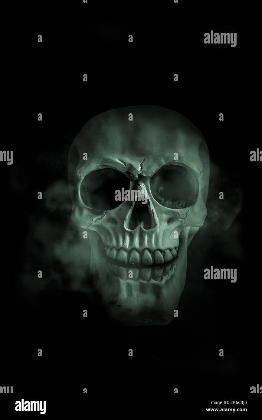 Glowing and smoking halloween skull Stock Photo
