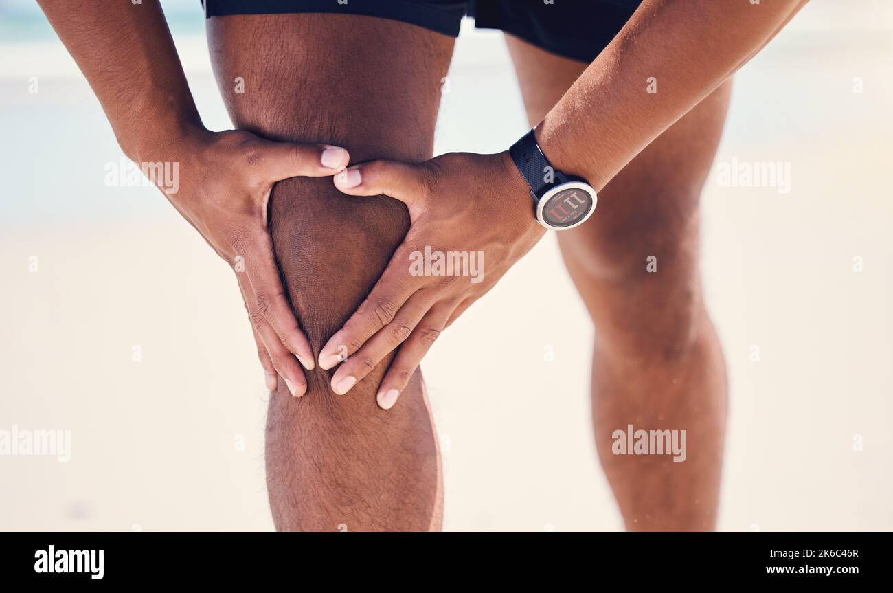 Oh, my knee. a man experiencing discomfort in his knee while out for a workout. Stock Photo