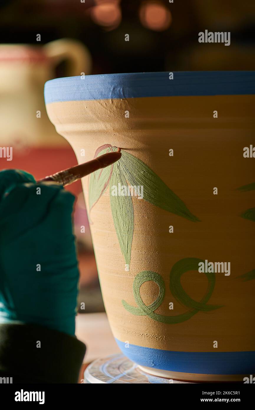Craftsman painting a flower in a pot Stock Photo Alamy